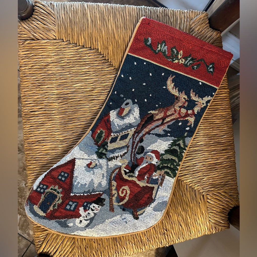 Vintage tapestry Christmas stocking featuring a festive, snowy scene with Santa
